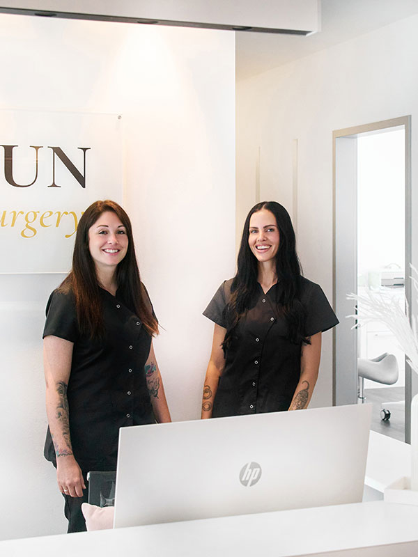 Zwei Frauen stehen l&auml;chelnd im Empfangsbereich